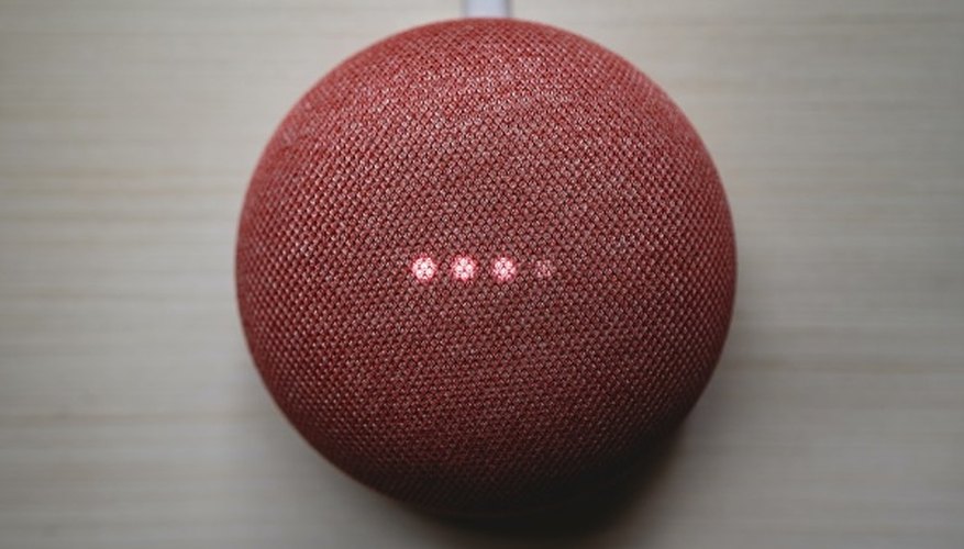 Red round portable speaker on brown wooden table.jpg