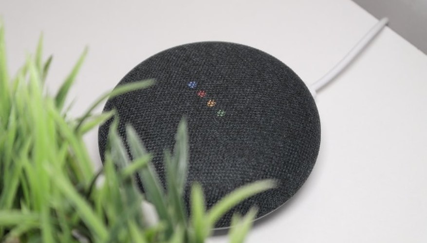 Black round portable speaker on white table.jpg