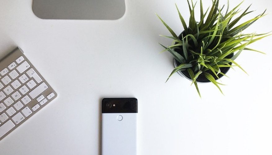 White google pixel phone beside keyboard.jpg