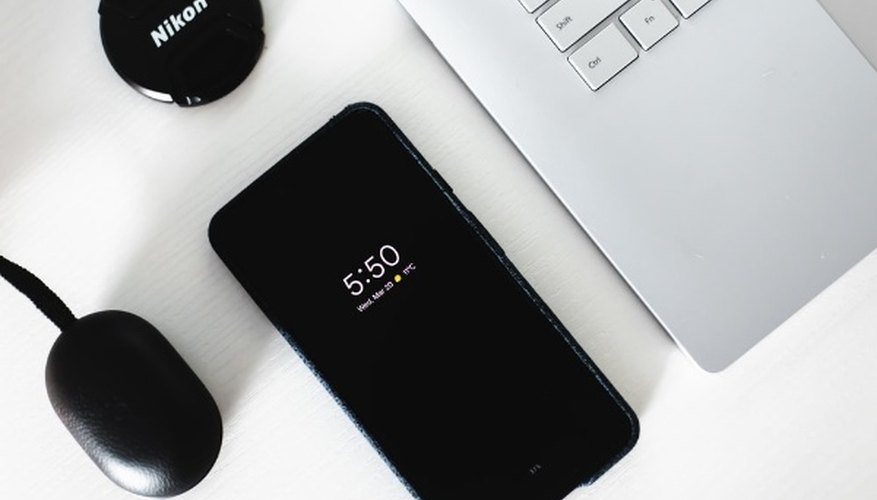 Black android smartphone beside grey laptop computer.jpg