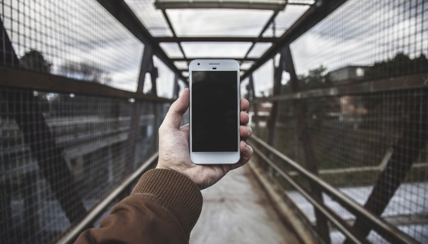Person holding white smartphone.jpg