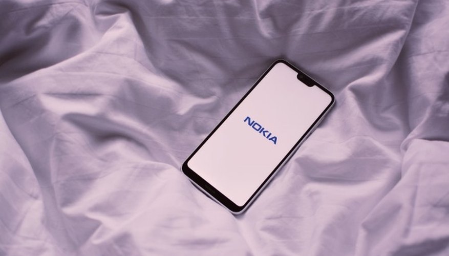 Black nokia phone on white textile.jpg
