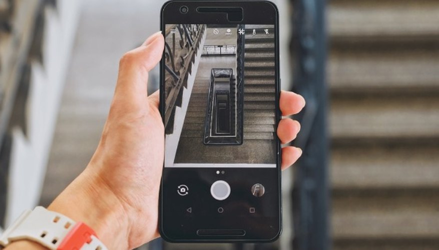 Person holding android smartphone displaying camera.jpg