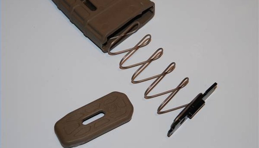 Magazine spring, lock plate and floorplate