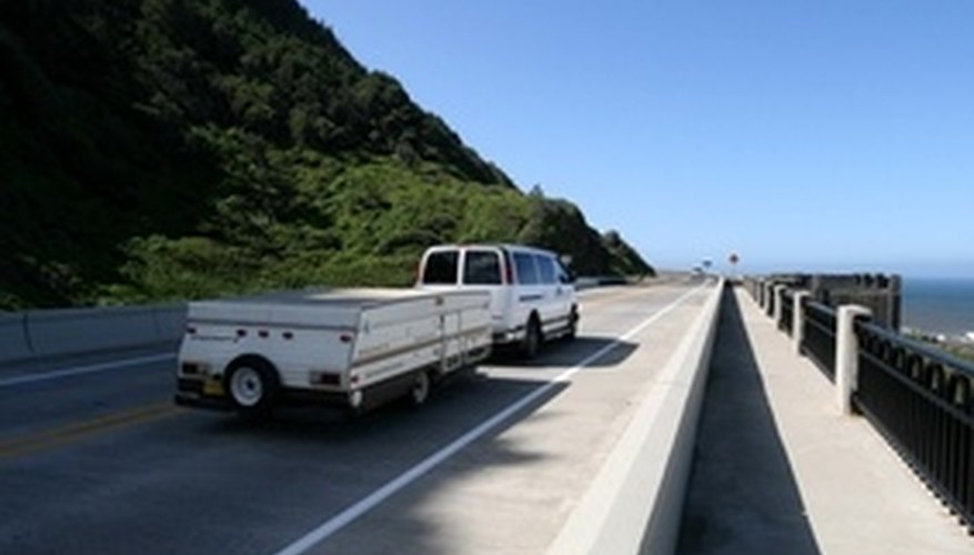 Photo Credit: camping,trailer image by Greg Pickens from <a href='http://www.fotolia.com'>Fotolia.com</a> Truck towing travel trailer