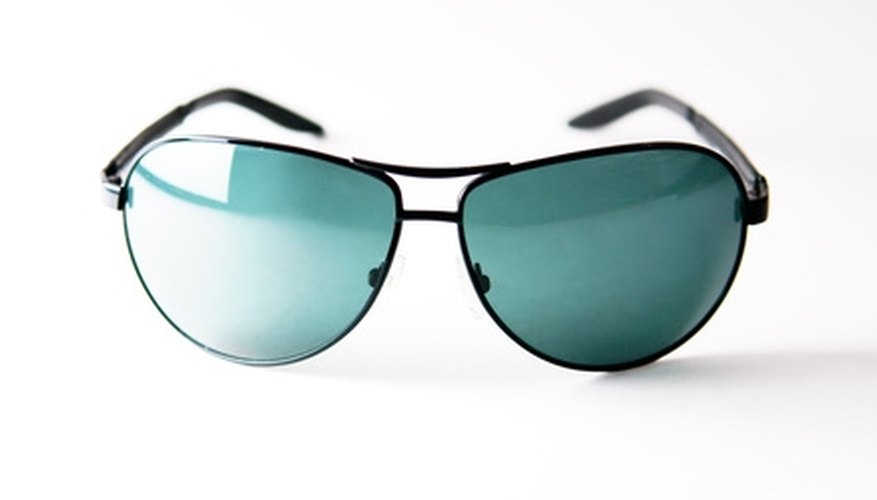 Photo Credit: sunglass image by Sergey from <a href='http://www.fotolia.com'>Fotolia.com</a> Green-tinted sunglasses boost color clarity.