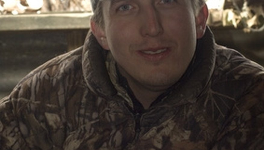 Photo Credit: duck hunter image by cherie from <a href='http://www.fotolia.com'>Fotolia.com</a> Opinion varies on the use of drugged arrows.