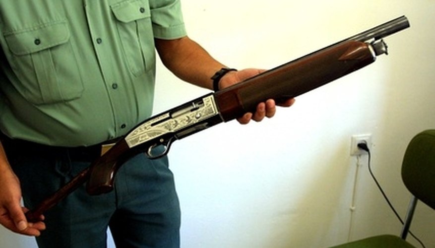 Photo Credit: cdtirot5 image by Paco Ayala from <a href='http://www.fotolia.com'>Fotolia.com</a> End-Cap on a Pump-Action Shotgun