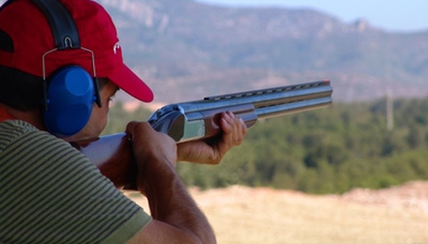 Photo Credit: tiro deportivo image by RAMON CAMI from <a href='http://www.fotolia.com'>Fotolia.com</a> Proper grip and stance can lessen the recoil effect