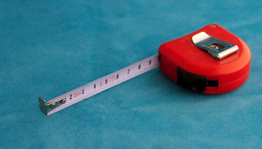 Photo Credit: red measuring tape image by Dumitrescu Ciprian from <a href='http://www.fotolia.com'>Fotolia.com</a> Measure for the correct amount of replacement flooring.