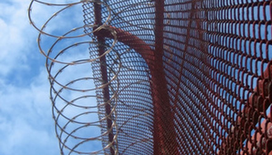 Prisons have barbed wire fences around their perimeters.