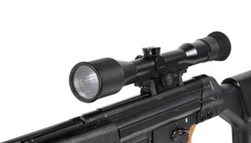 Photo Credit: sniper rifle on the tripod and optical sight image by Vladimir Melnik from <a href='http://www.fotolia.com'>Fotolia.com</a> Adjusting the scope is a trial-and-error process.