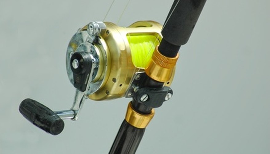 Photo Credit: fishing reel image by itsallgood from <a href='http://www.fotolia.com'>Fotolia.com</a> Saltwater fishing requires heavy setups which call for baitcaster reels.