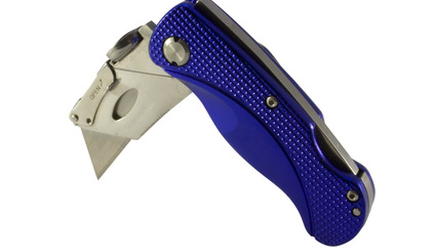 Photo Credit: folding utility knife image by Christopher Dodge from <a href='http://www.fotolia.com'>Fotolia.com</a> A heavy duty utility knife is fine for single stall mats.
