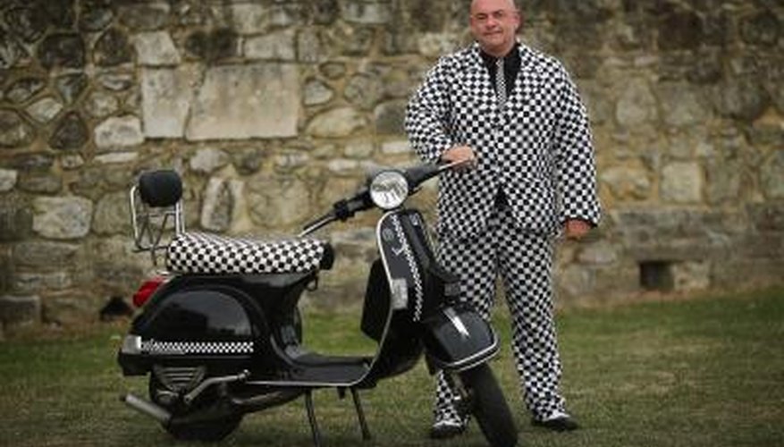 Photo Credit: Dan Kitwood/Getty Images News/Getty Images Man with Vespa PX 200