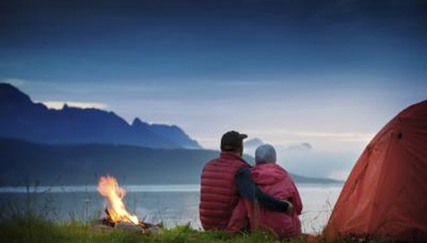 Photo Credit: Andrey Kryuchkov/iStock/Getty Images Couple hugging outside tent