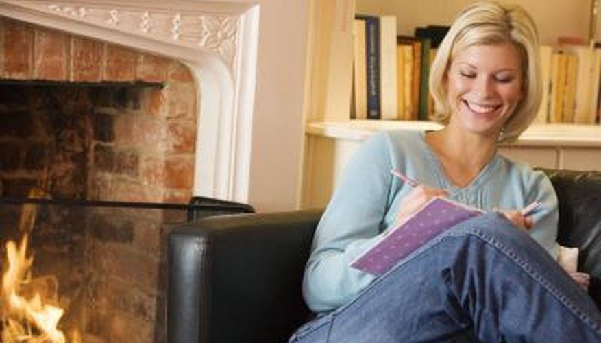Photo Credit: BananaStock/BananaStock/Getty Images Woman sitting next to fireplace