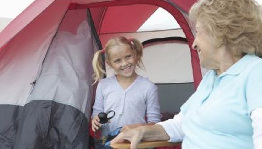Photo Credit: moodboard/moodboard/Getty Images Little girl smiling outside tent
