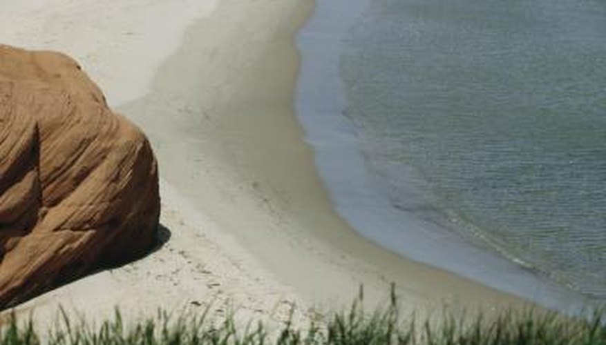 Photo Credit: Photos.com/Photos.com/Getty Images Tides occur due to the gravitational pull of the moon on the earth's oceans.