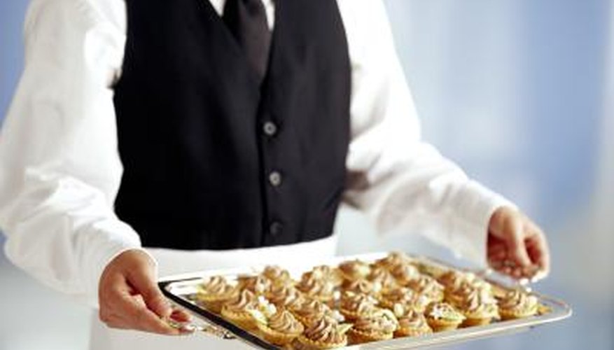 A professional caterer with a tray of food.