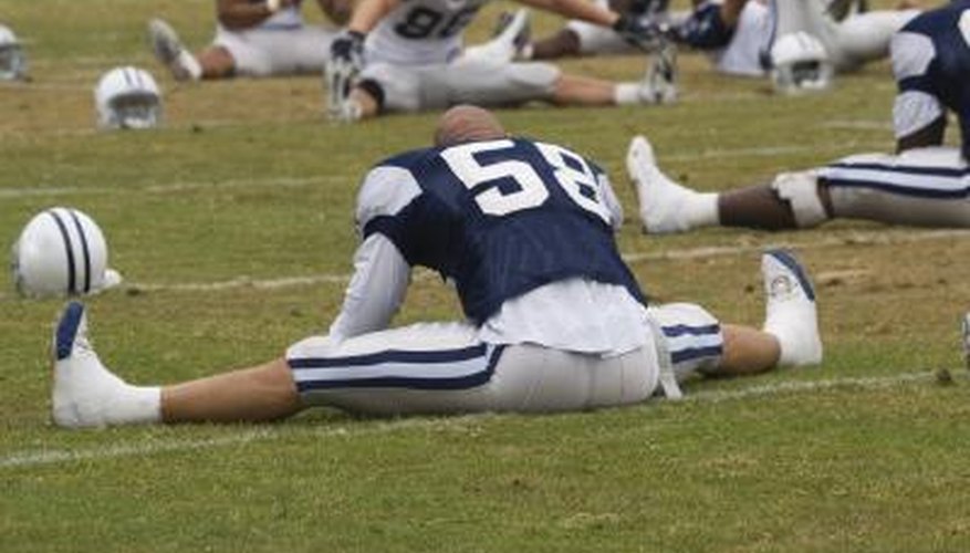 NFL football player stretching.