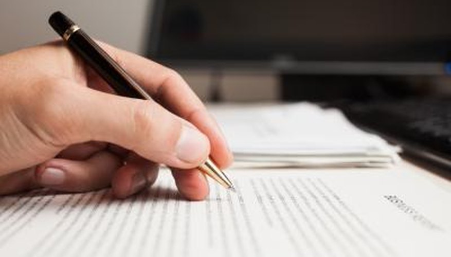 Male checking a document for errors.