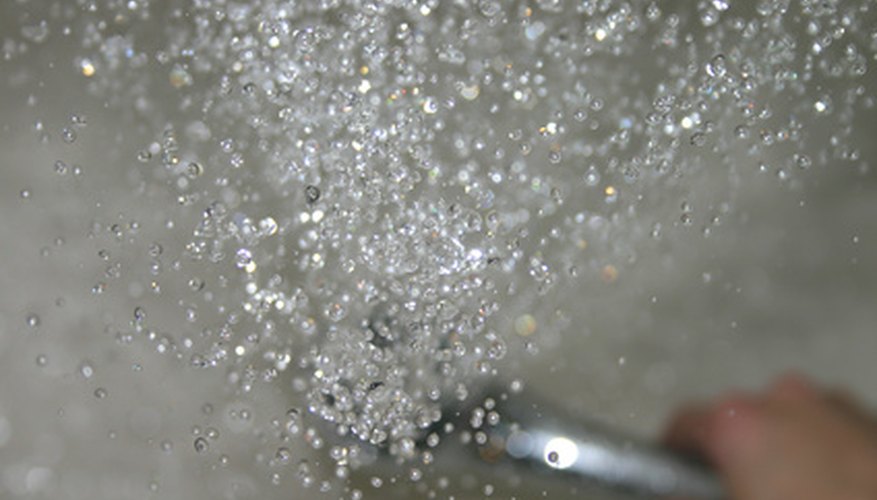 Hard water can leave white deposits on shower doors.
