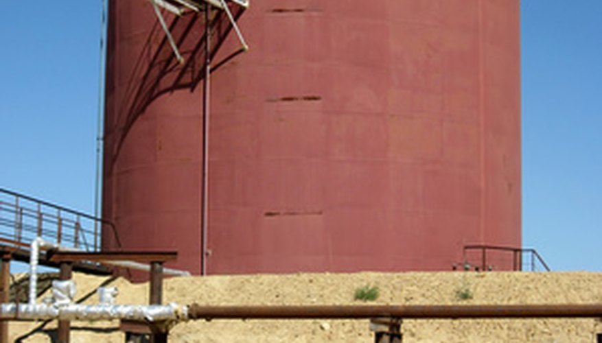Large oil tanks require the use of a boom lift for painting.