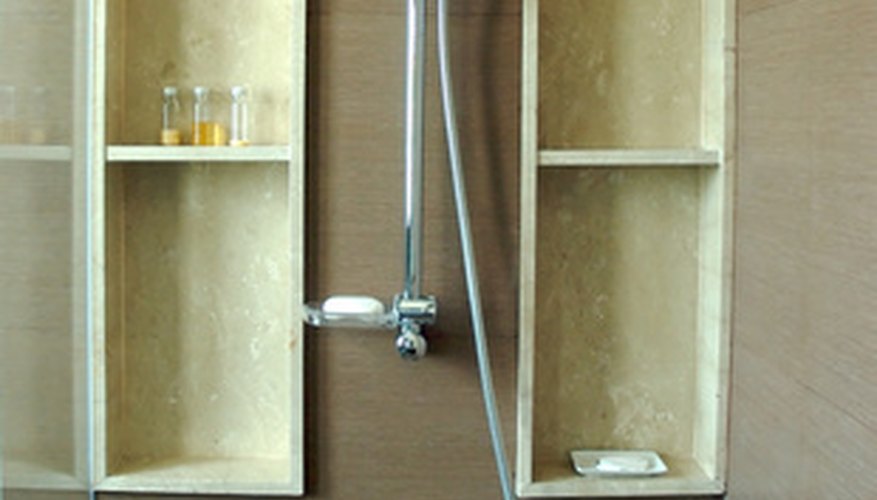 A shower with a hand held sprayer.