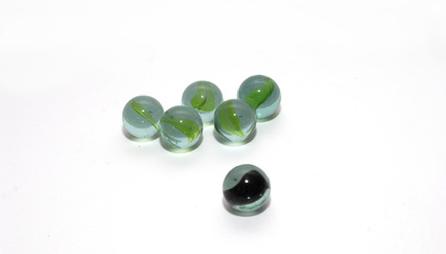 Machine-made glass marbles lack the pontil mark found on handmade marbles.