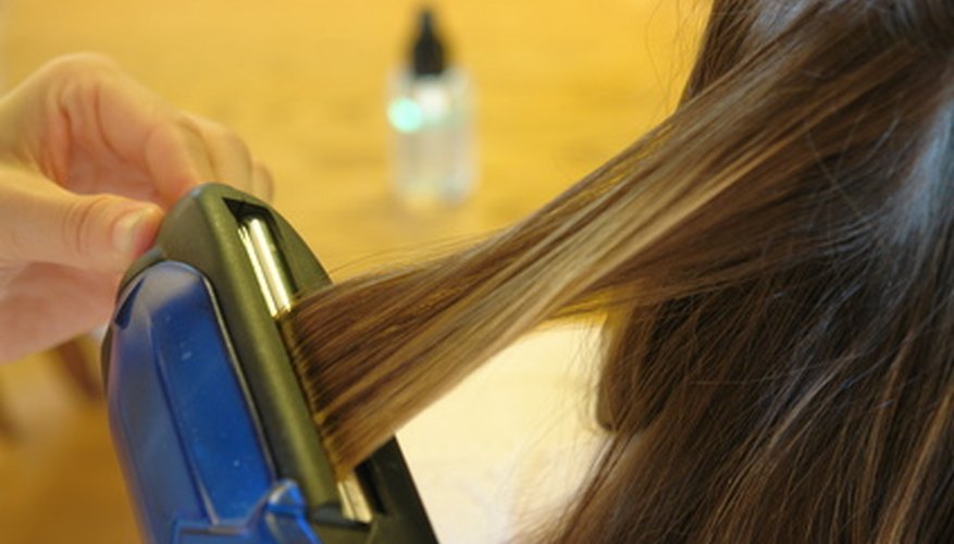 Taming a cowlick can be achieved with hairspray and a flat iron.