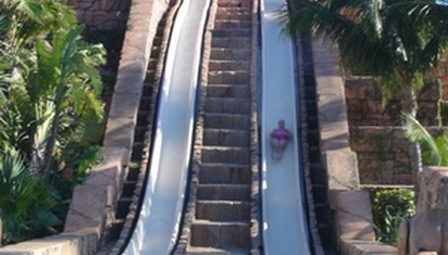 Water slides send riders into a pool.