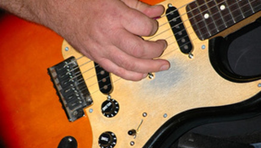 An archtop guitar's stings are grounded like any other electric guitar.