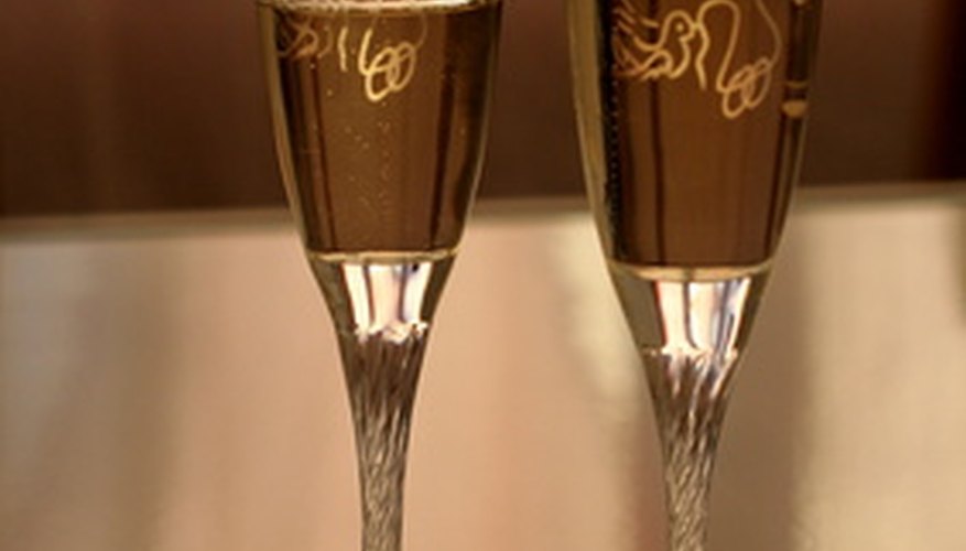 Decorate plastic champagne flutes by etching them.