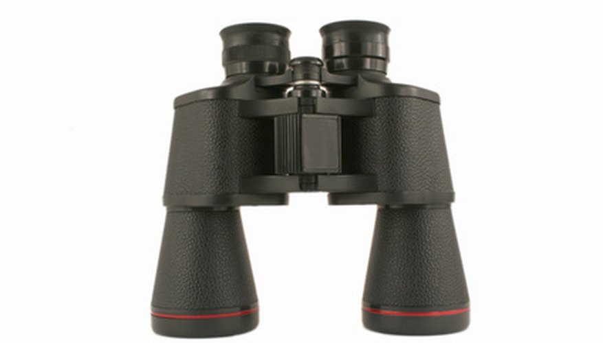 Clean interior lenses of binoculars by disassembling them.