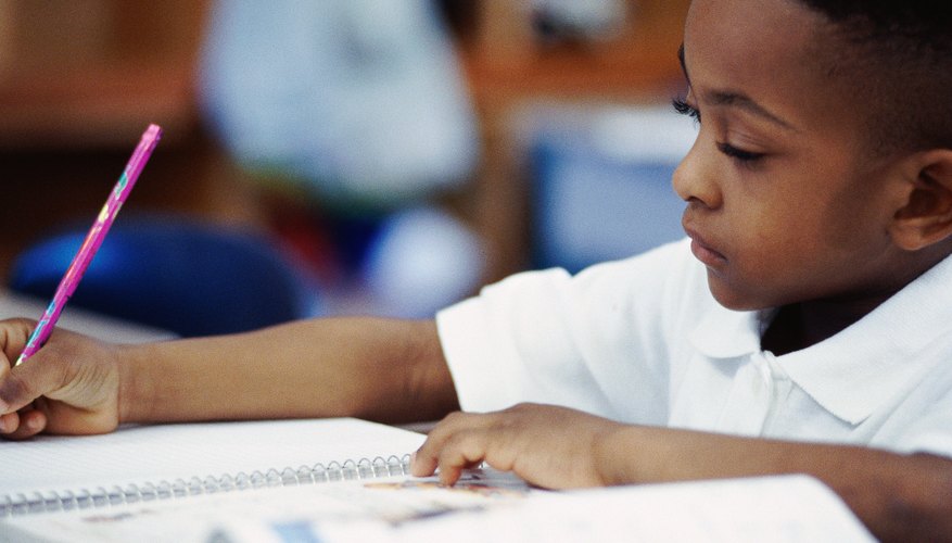 boy writing in notebook