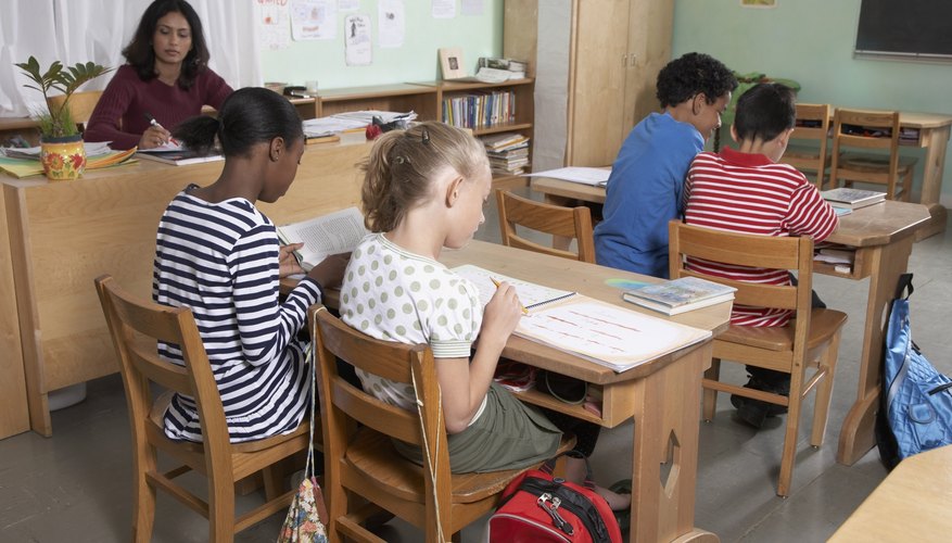 Students working at desks in classroom.
