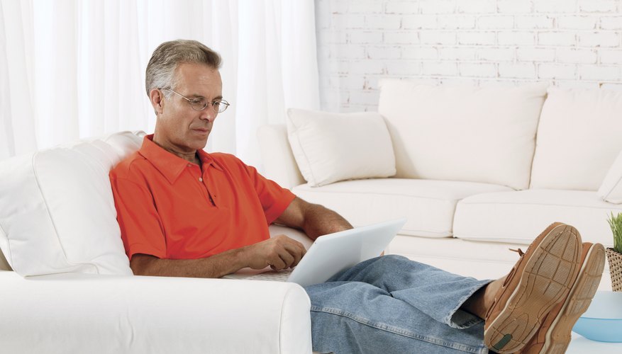 Man working on laptop at home.