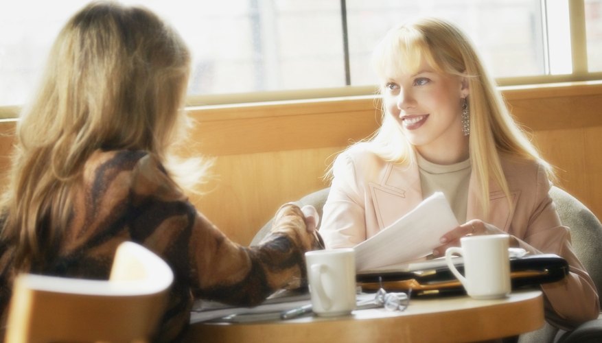A woman is tutoring a young girl.