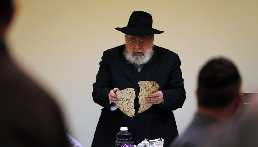 The seder leader breaks one piece of matzah in half, creating the afikomen.