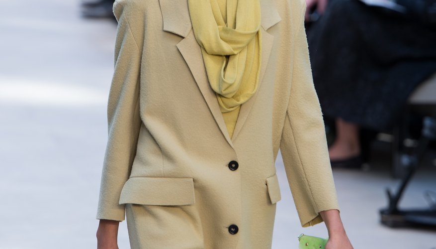Plaids or brights are more typical, but a Burberry Prorsum model shows that pale pastels can work, too.