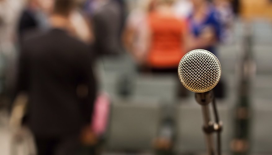 Close-up of microphone in front of auditorium.