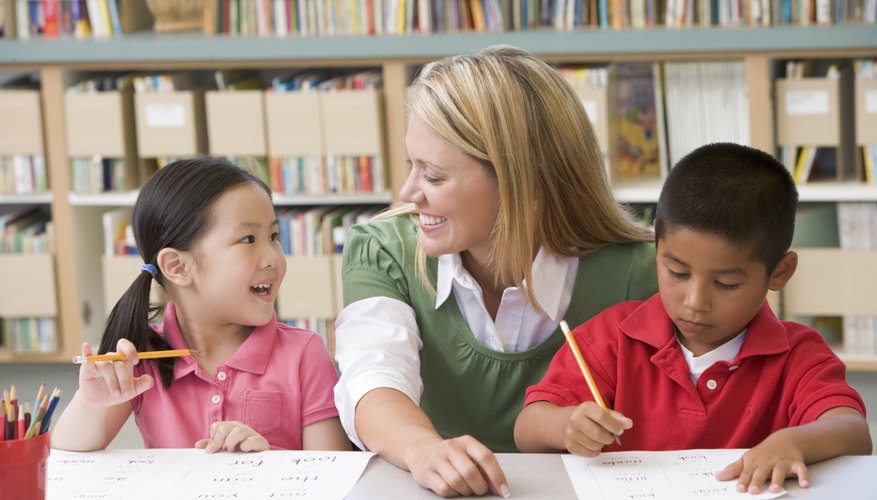 Preschool teacher talking to students in library