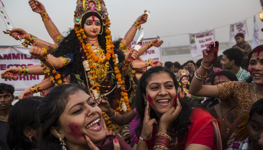 During a Durga festival, a statue of the goddess is carried through the streets.