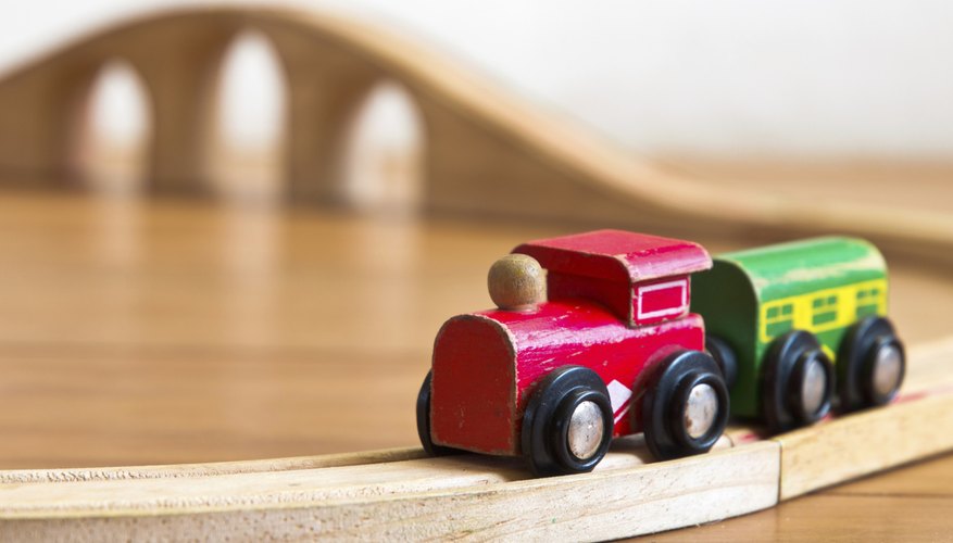 A toy wood train set and tracks.