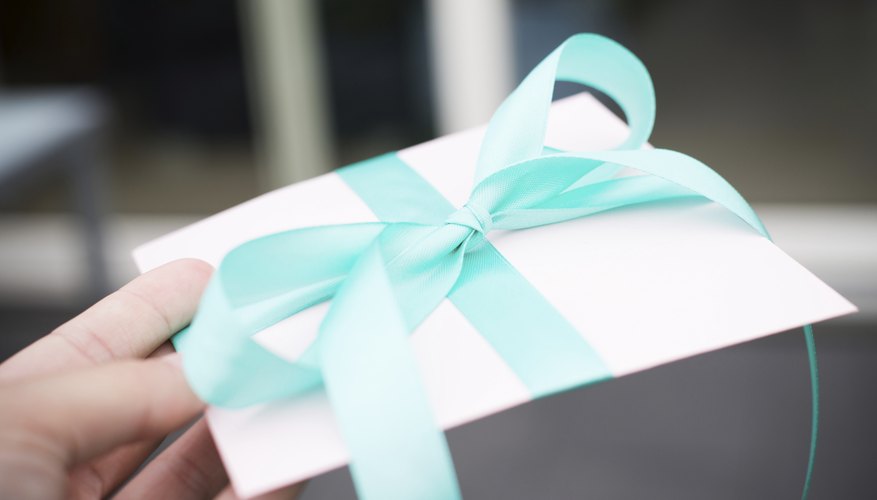 Handing over a wrapped envelope.