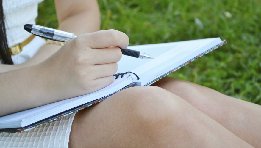 Close-up of student writing in notebook.