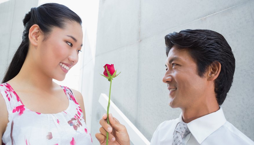 Korean man giving a flower to his date.