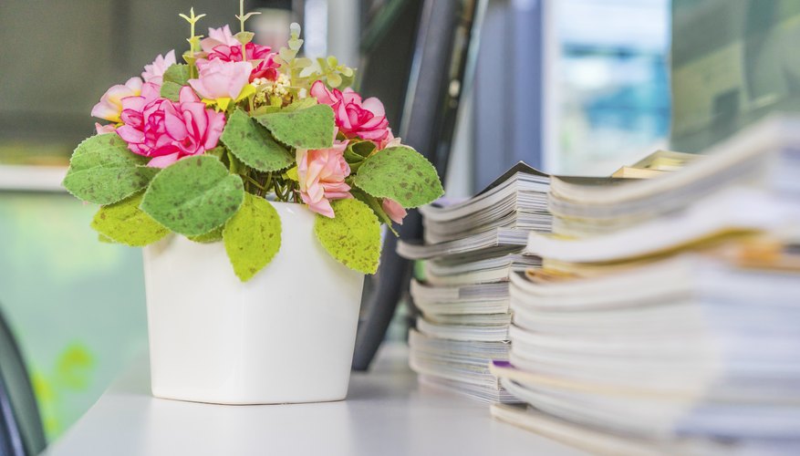 A floral arrangement sitting on a desk in the office.