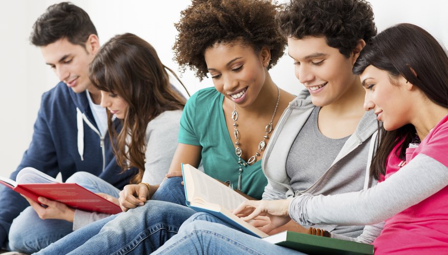 MBA candidates look through text books together